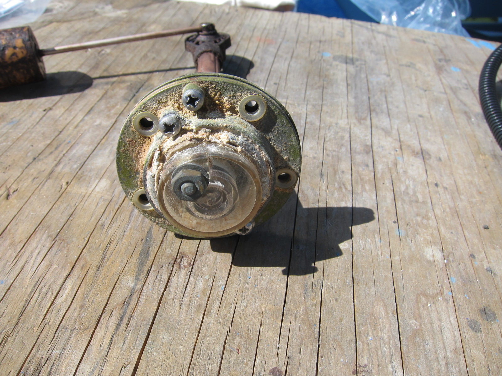 The sender top is full of tan granules of corrosion.